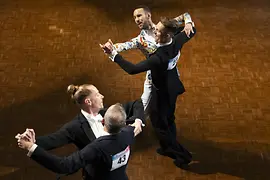 Dos parejas masculinas bailando en un salón durante los EuroGames 2023 en Suiza